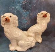 A pair of Victorian Staffordshire dogs, standing to the left and right, 30cm high, c.1860