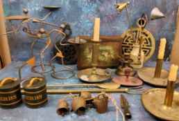 A pair of brass chamber sticks;   others;   a Wrights Biscuit Ltd tin;  trivets;  figural wirework