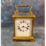 A 20th century brass carriage clock, Roman numerals, swing handle, 10cm high