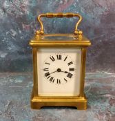 A 20th century brass carriage clock, Roman numerals, swing handle, 10cm high
