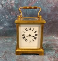 A 20th century brass carriage clock, Roman numerals, swing handle, 10cm high