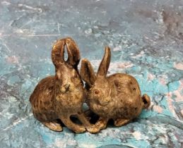 An Austrian cold painted bronze model, of a pair of rabbits, 4cm high, marked Geschutzt