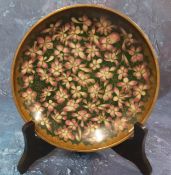 A Japanese cloisonne dish, decorated with pink blossom on a green ground, 18.5cm diam, Meiji period