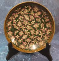 A Japanese cloisonne dish, decorated with pink blossom on a green ground, 18.5cm diam, Meiji period