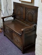 An early 20th century oak monk's bench