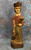 An 18th century polychrome carving, of a lawyer, standing in robes, holding a book, 30.5cm high