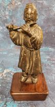 Chinese School, possibly 17th century, a dark patinated bronze, of a musician playing a flute,