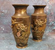 A pair of Japanese bronze ovoid vases, in relief with blossoming peonies, 15cm high, Meiji period