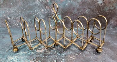 A Victorian silver plated seven-bar concertina toast rack, loop handle, bun feet,  40cm long