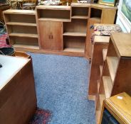 Heal's - a mid 20th century limed oak adjustable library suite, the four stepped sections holding
