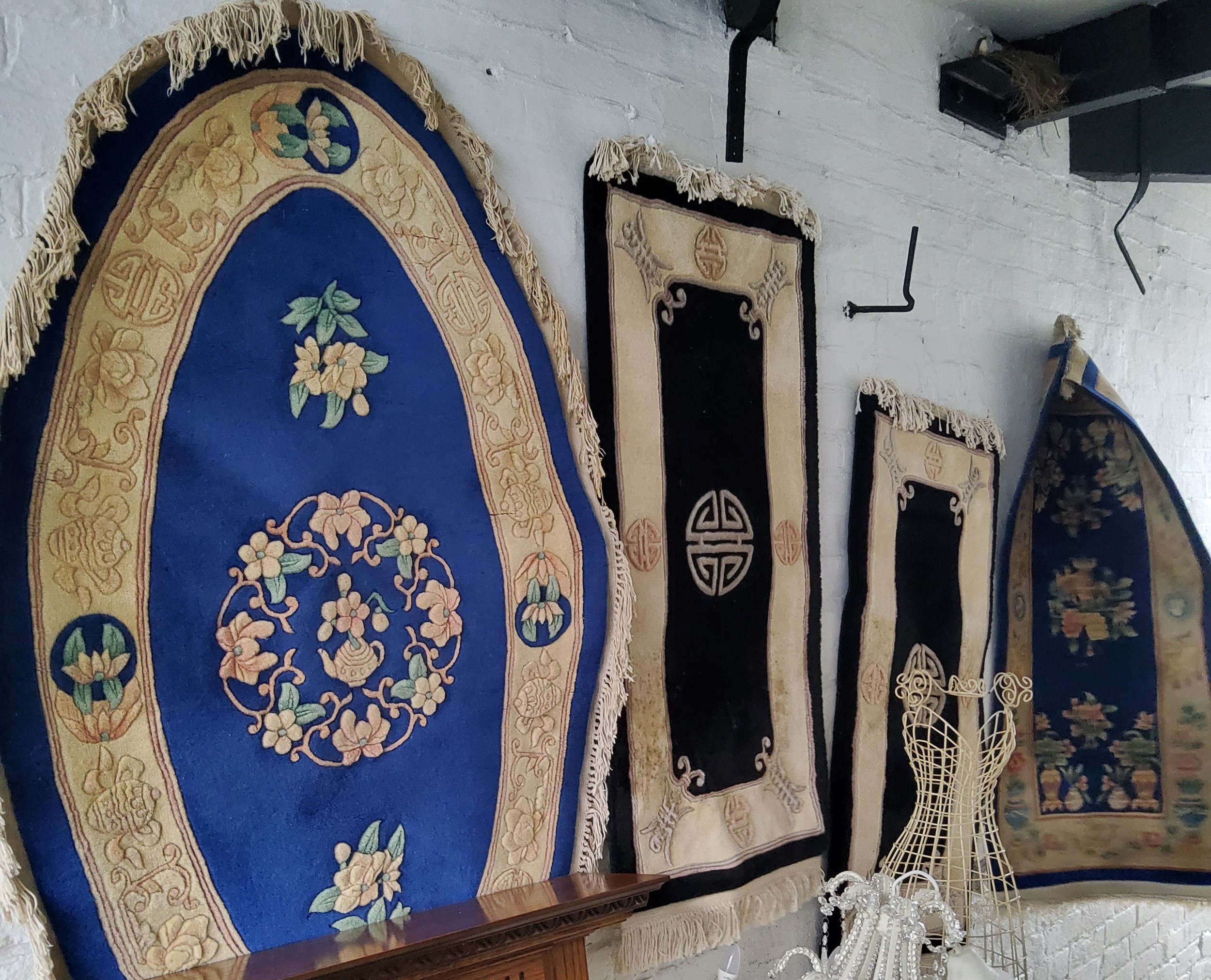 A Chinese oval woollen rug, with floral motiff, on a buff ground, 155cm x 98cm wide;  another, 135cm