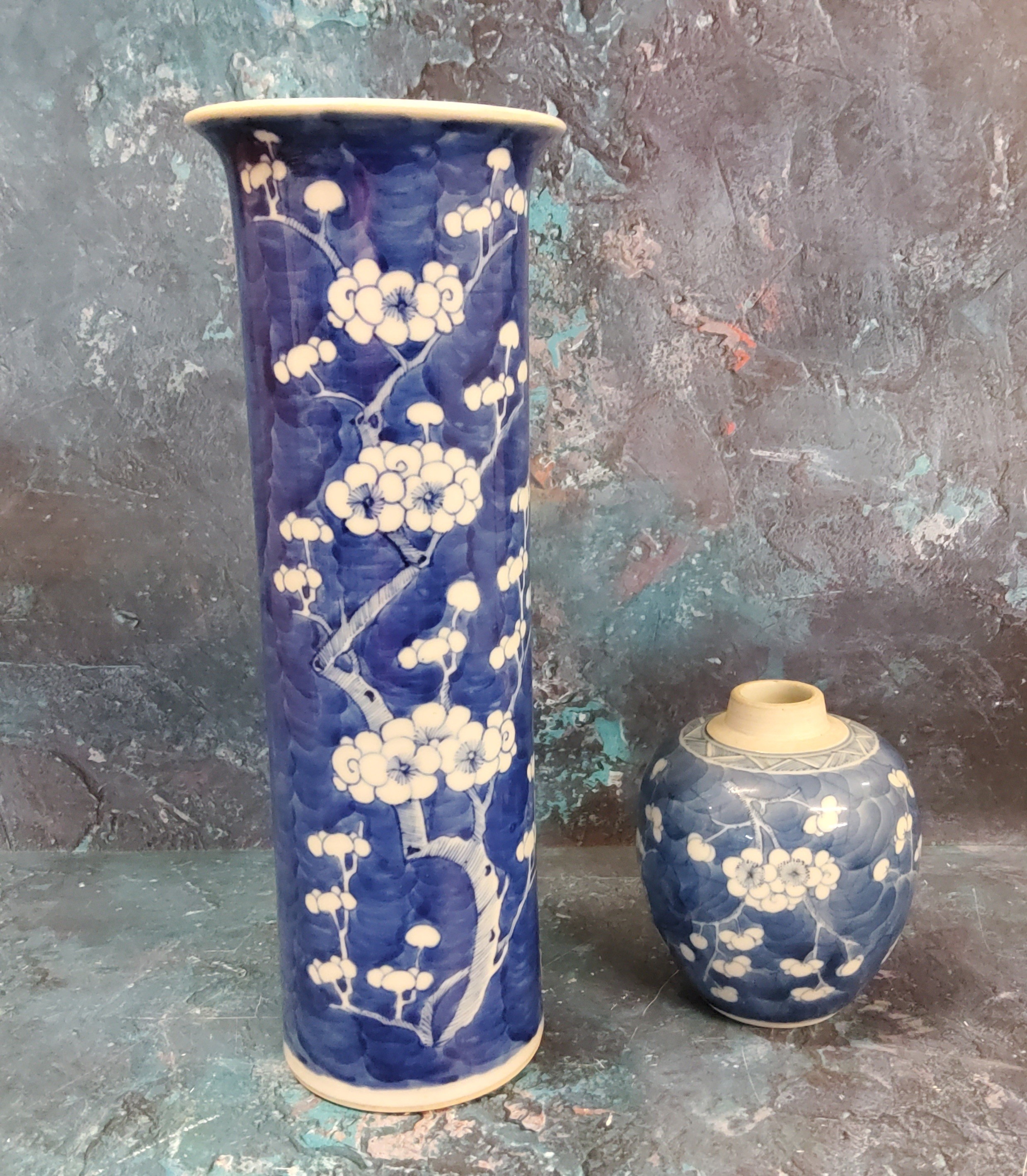 A Chinese cylindrical vase, decorated with prunus blossom on a blue ground, 30.5cm high, Kangxi