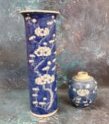 A Chinese cylindrical vase, decorated with prunus blossom on a blue ground, 30.5cm high, Kangxi