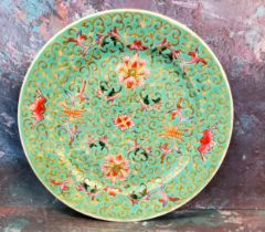 A Cantonese circular side plate, decorated with stylised flowerheads on a turquoise ground, 18cm