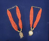A Middle Eastern ceremonial necklace, with circular white paste disc, suspended on beaded coral