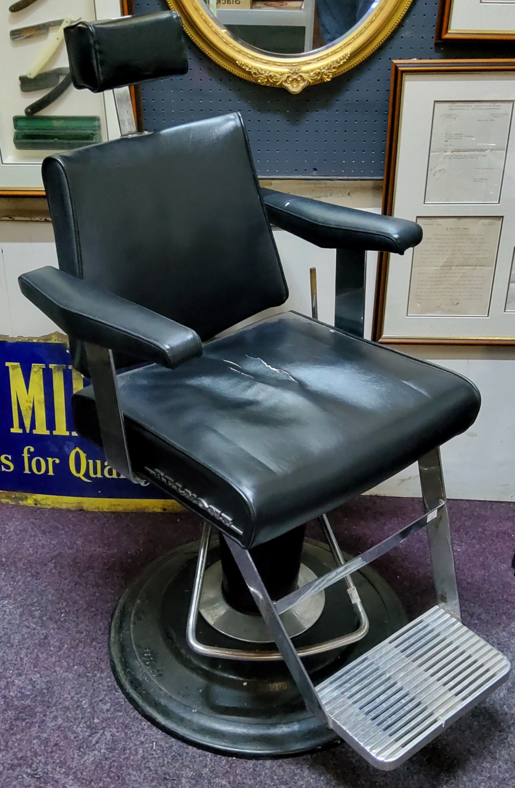 A 1950s Belmont barbers chairs, adjustable headrest, chromed fittings, on stepped weighted base.