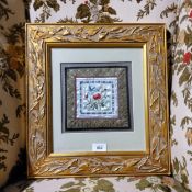 A 19th century Chinese silk, embroidered with flowers and foliage, 18cm square, framed