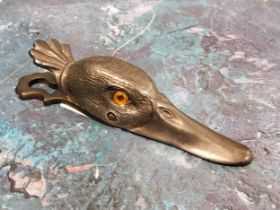 A 20th century plated money clip,  in the form of a duck,  with glass eyes, 13cm long