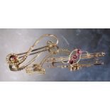 A 9ct gold bar brooch, centrally collet set with three pink round stones, flanked by two seed