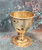 An 18th/19th century silver coloured metal chalice, half fluted bowl, knopped stem, stepped base,