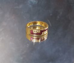 A continental 18ct gold ruby & diamond ring, chanel set with seven baguette rubies & three round