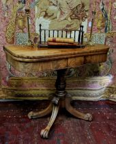 An early 19th century flamed mahogany tea table