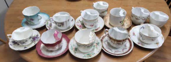 Moustache Cups - a Limoges cup and saucers, printed with colourful flowers, c.1910;  others, late