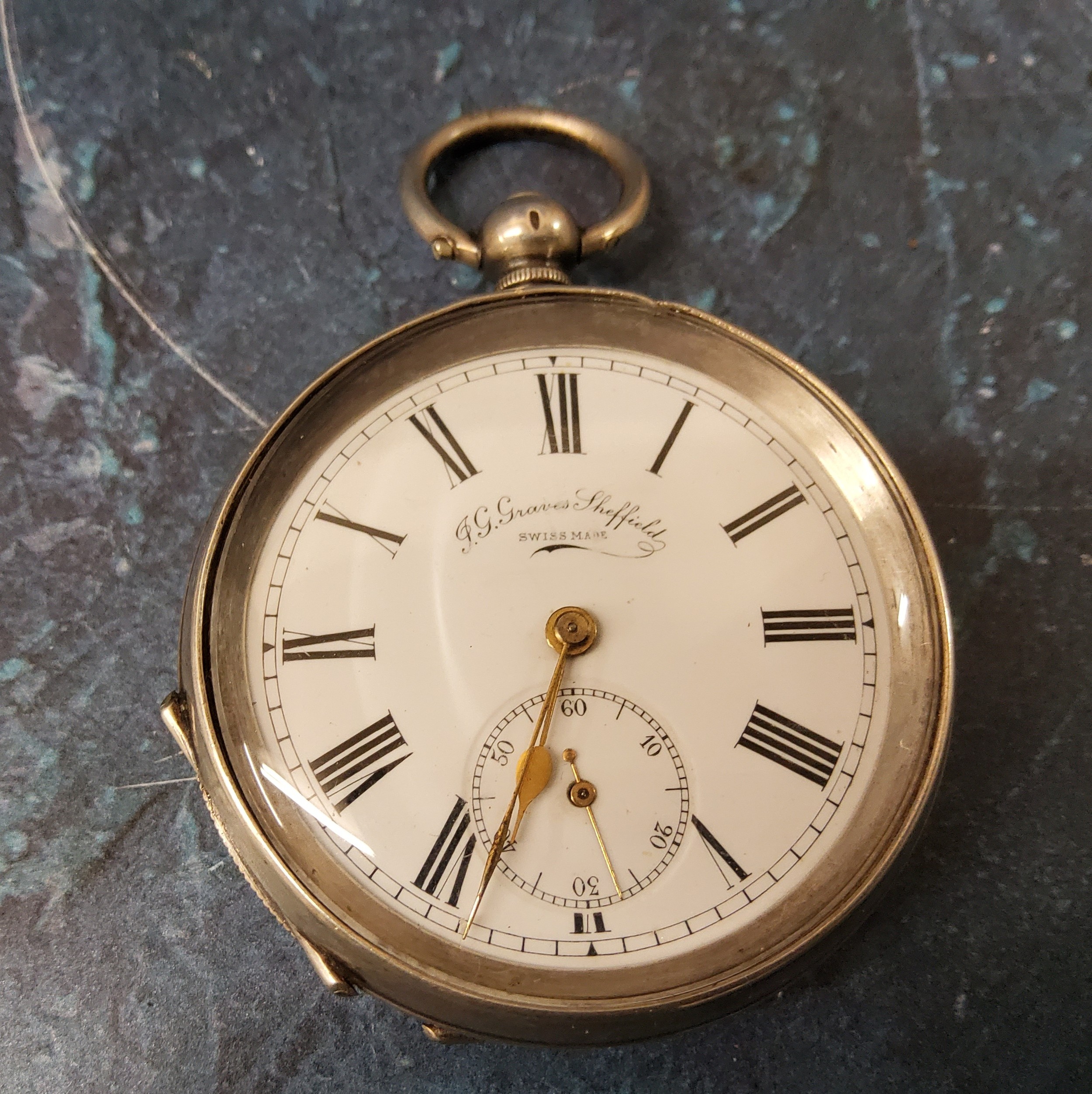 A silver coloured metal open faced pocket watch, J G Graves, Sheffield