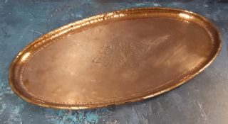 Hugh Wallace - a copper oval tray, engraved with stylised tree, hammered sides, folded rim, 43cm