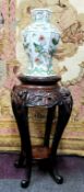 A 19th century Chinese hardwood jardiniere / temple vase stand, carved with oriental iris flower