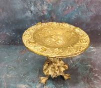 A 19th century gilt bronze tazza, the circular top in relief with maiden within a border of