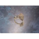 A 9ct white gold and diamond pear shaped cluster ring, stepped setting, each shoulder set with seven