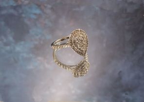 A 9ct white gold and diamond pear shaped cluster ring, stepped setting, each shoulder set with seven