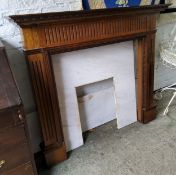 A contemporary mahogany and marble fire surround