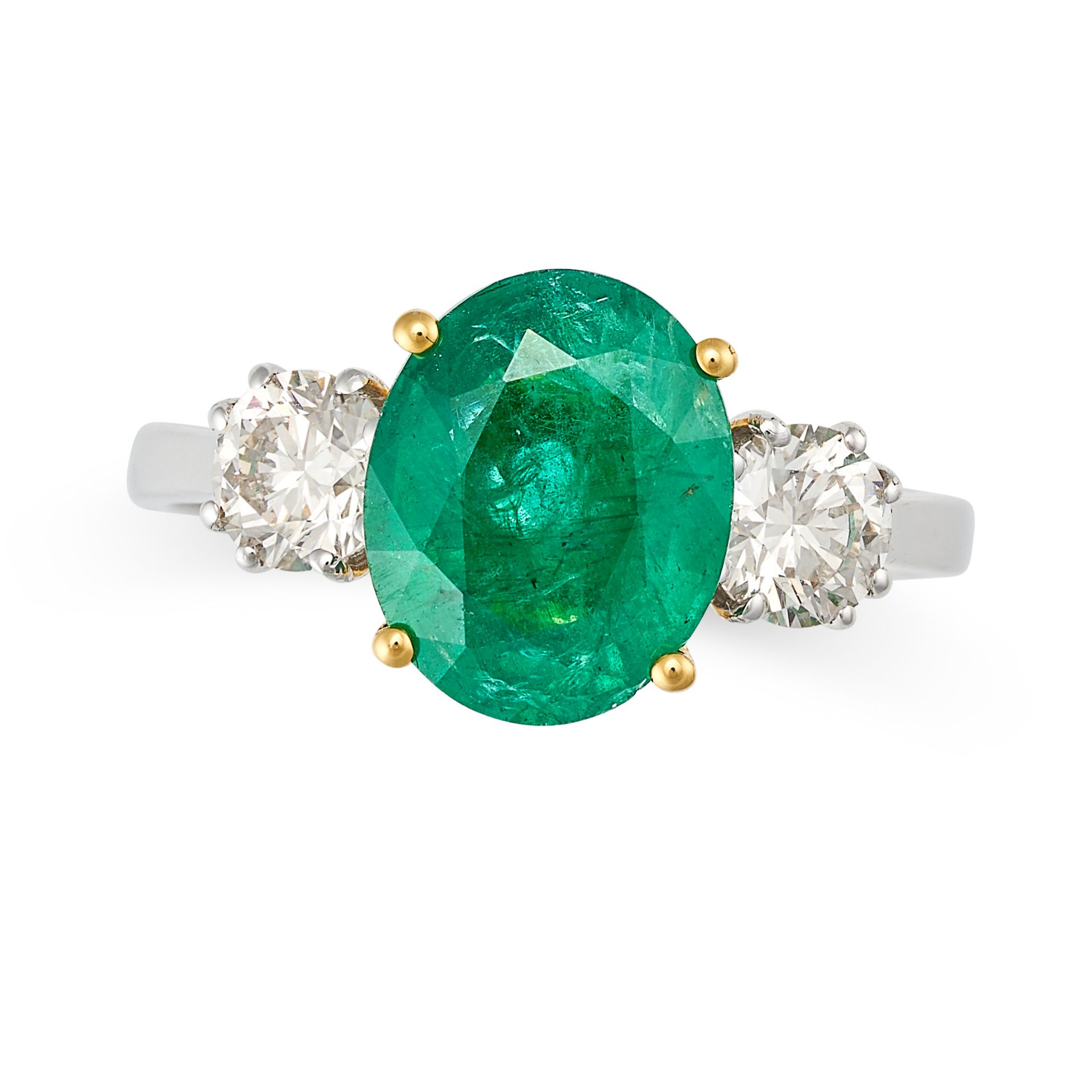 AN EMERALD AND DIAMOND THREE STONE RING in 18ct white and yellow gold, set with an oval cut emera...