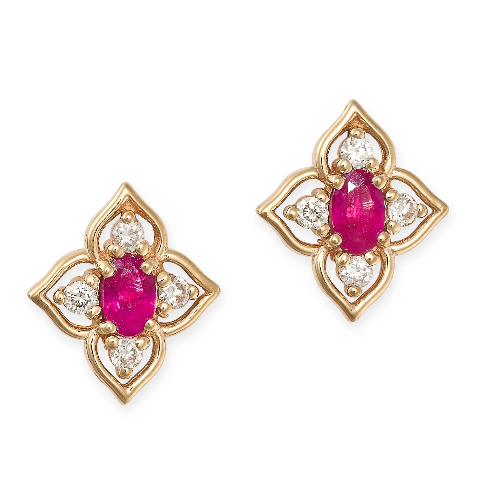 A PAIR OF RUBY AND DIAMOND STUD EARRINGS in yellow gold, each designed as a quatrefoil motif set ...