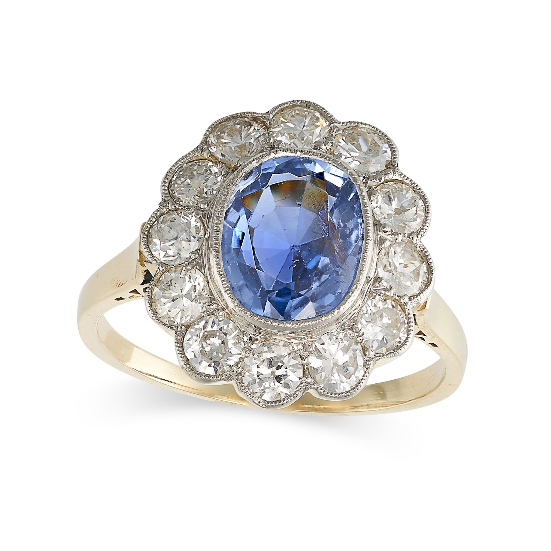 A CEYLON NO HEAT SAPPHIRE AND DIAMOND CLUSTER RING in yellow gold, set with an oval cut sapphire ...