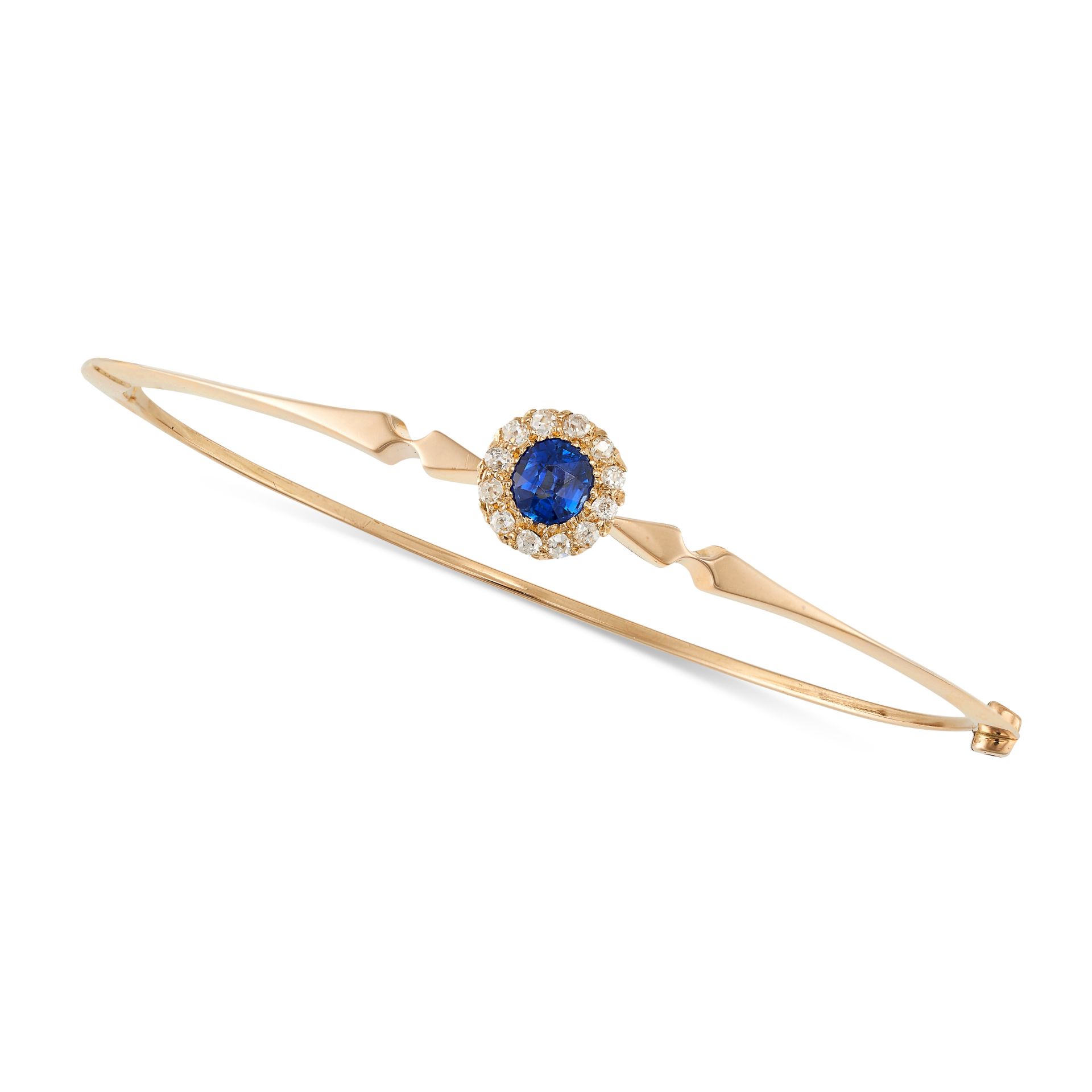 AN ANTIQUE SAPPHIRE AND DIAMOND BANGLE in 15ct yellow gold, the hinged body set with a round cut ...