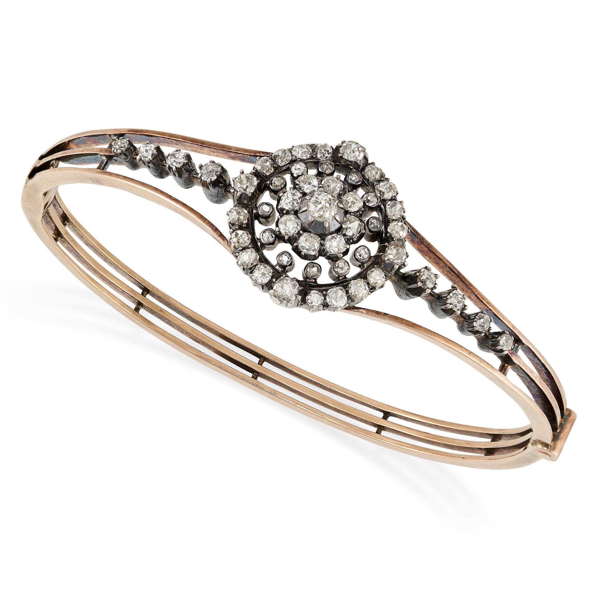 AN ANTIQUE DIAMOND BANGLE in yellow gold and silver, the hinged bangle set with a cluster of old ...