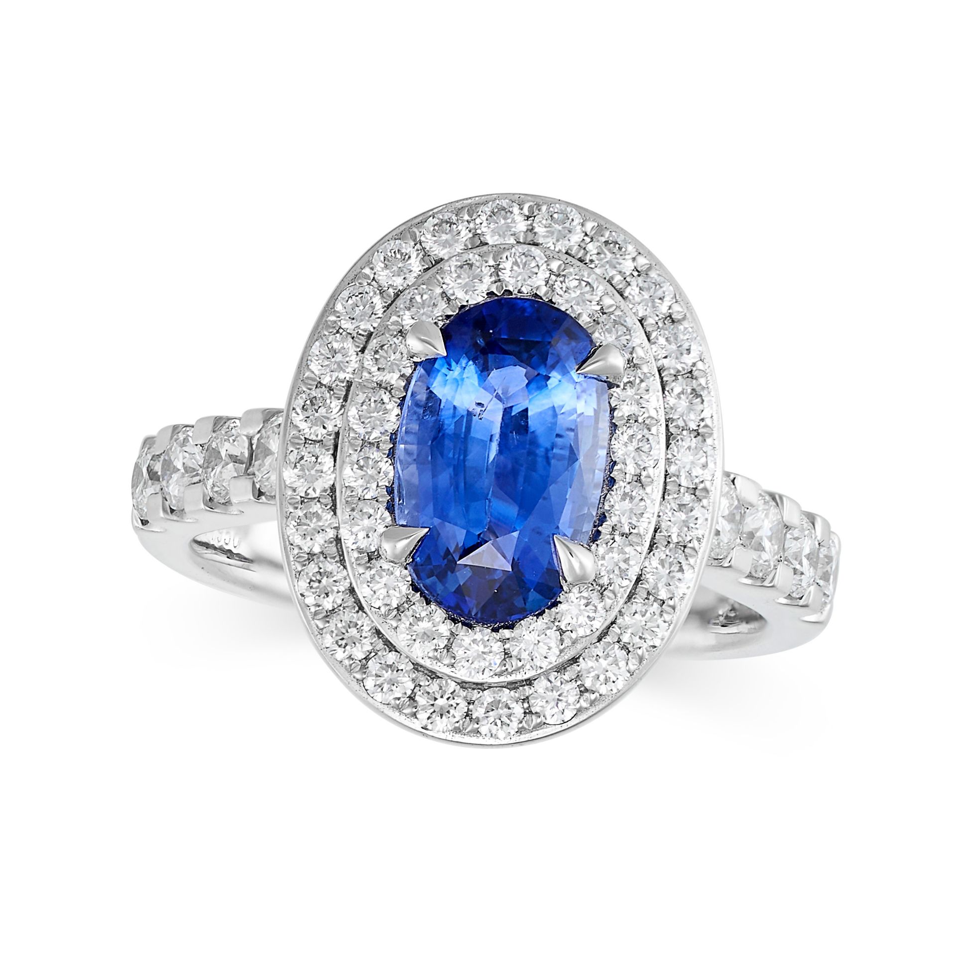 A SAPPHIRE AND DIAMOND CLUSTER RING in platinum, set to the centre with an oval cut sapphire of 2...