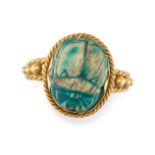 AN EGYPTIAN REVIVAL SCARAB BEETLE RING in yellow gold, set with a carved blue hardstone scarab be...
