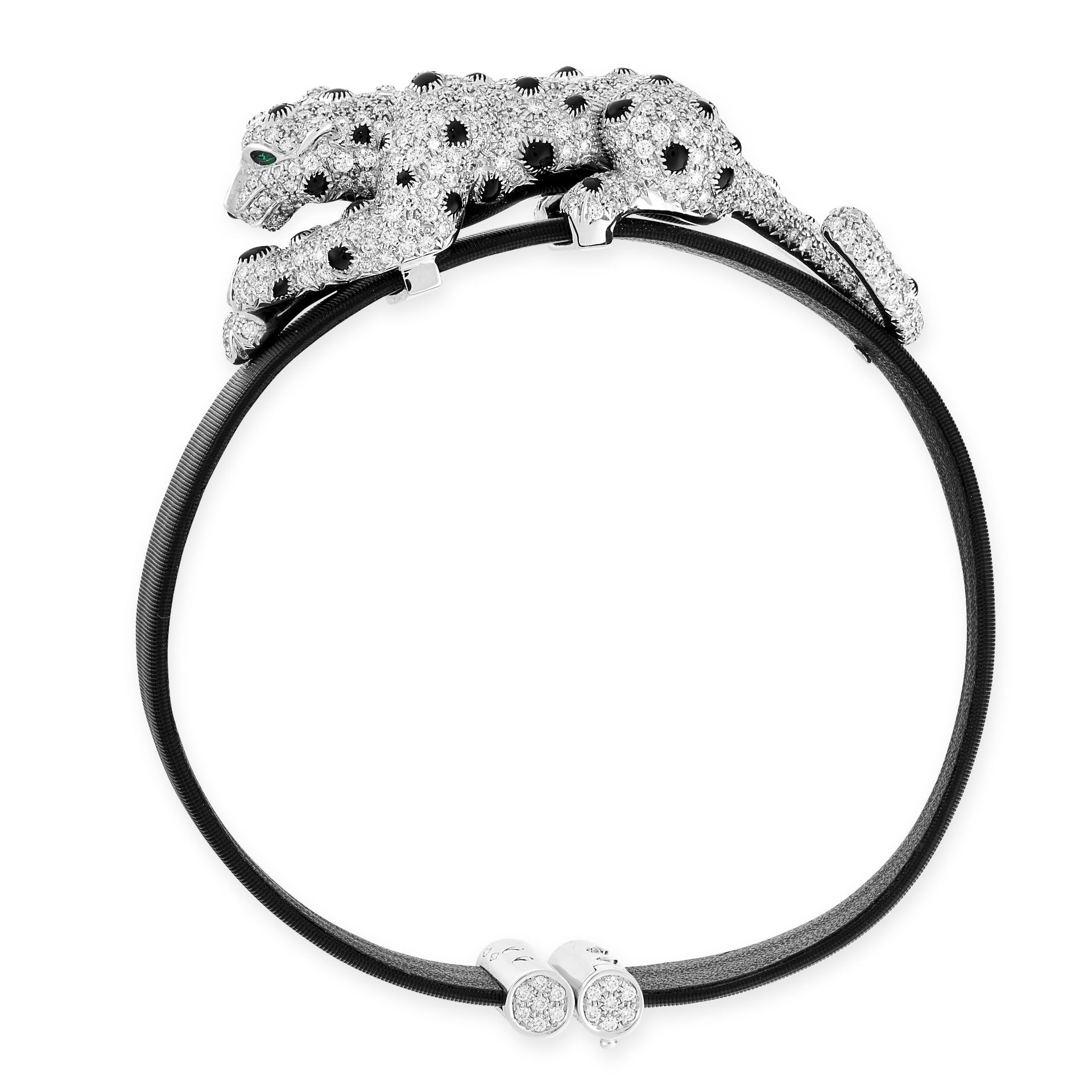 A DIAMOND, ONYX AND EMERALD PANTHER BRACELET in 18ct white gold, the panther set with round cut d...