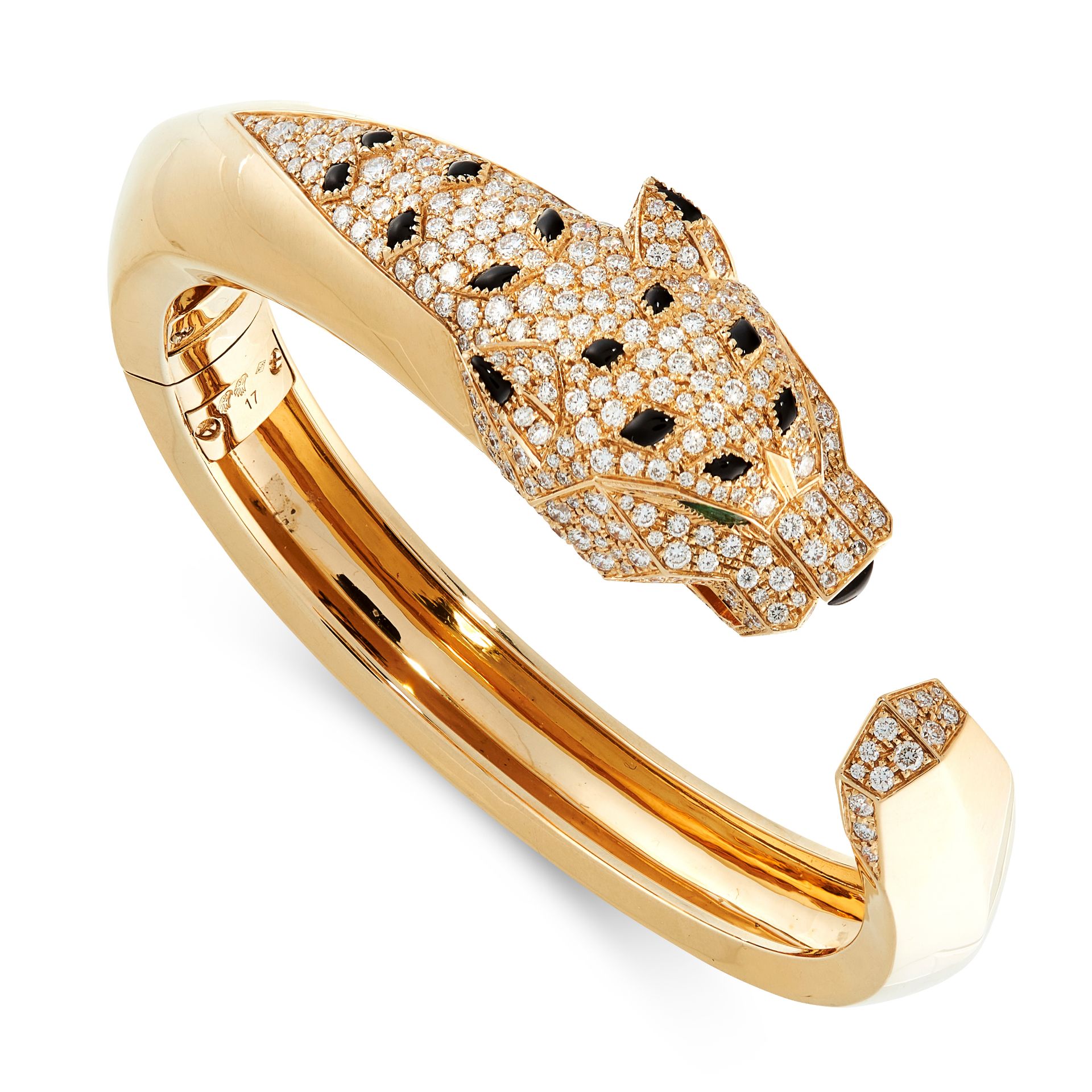 A DIAMOND, ONYX AND EMERALD PANTHER BANGLE in 18ct yellow gold, designed as a coiled panther, set...