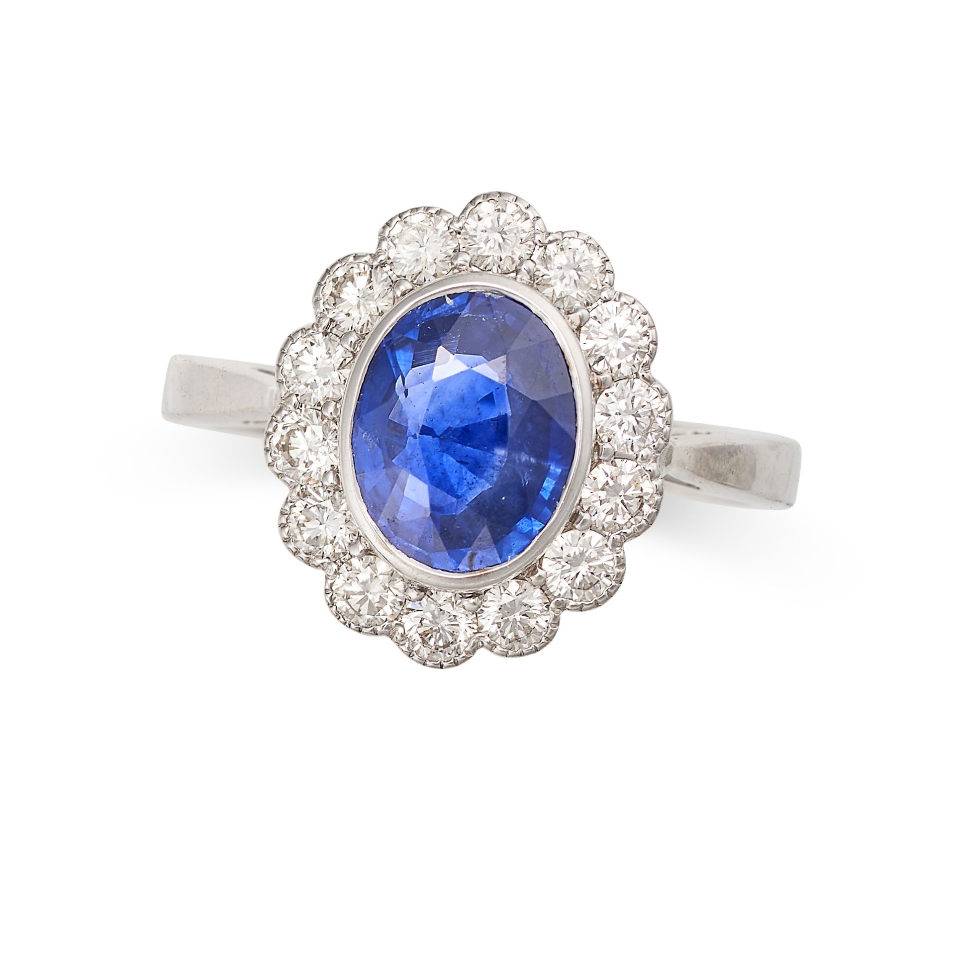 A SAPPHIRE AND DIAMOND CLUSTER RING in white gold, set with an oval cut sapphire of approximately...