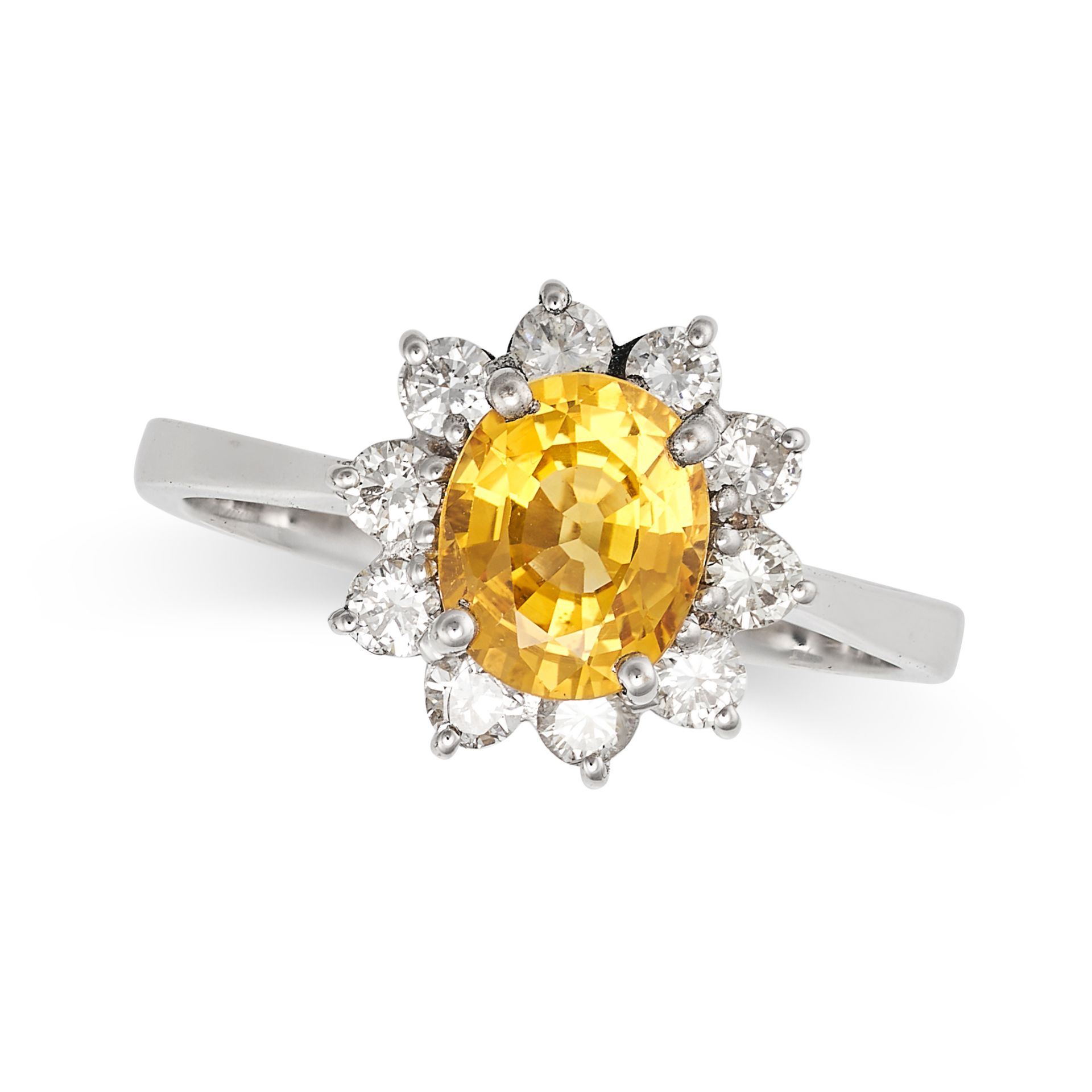 A YELLOW SAPPHIRE AND DIAMOND CLUSTER RING in 18ct white gold, set with an oval cut yellow sapphi...