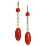 A PAIR OF CORAL AND PEARL DROP EARRINGS in yellow gold, each set with a polished coral bead suspe...