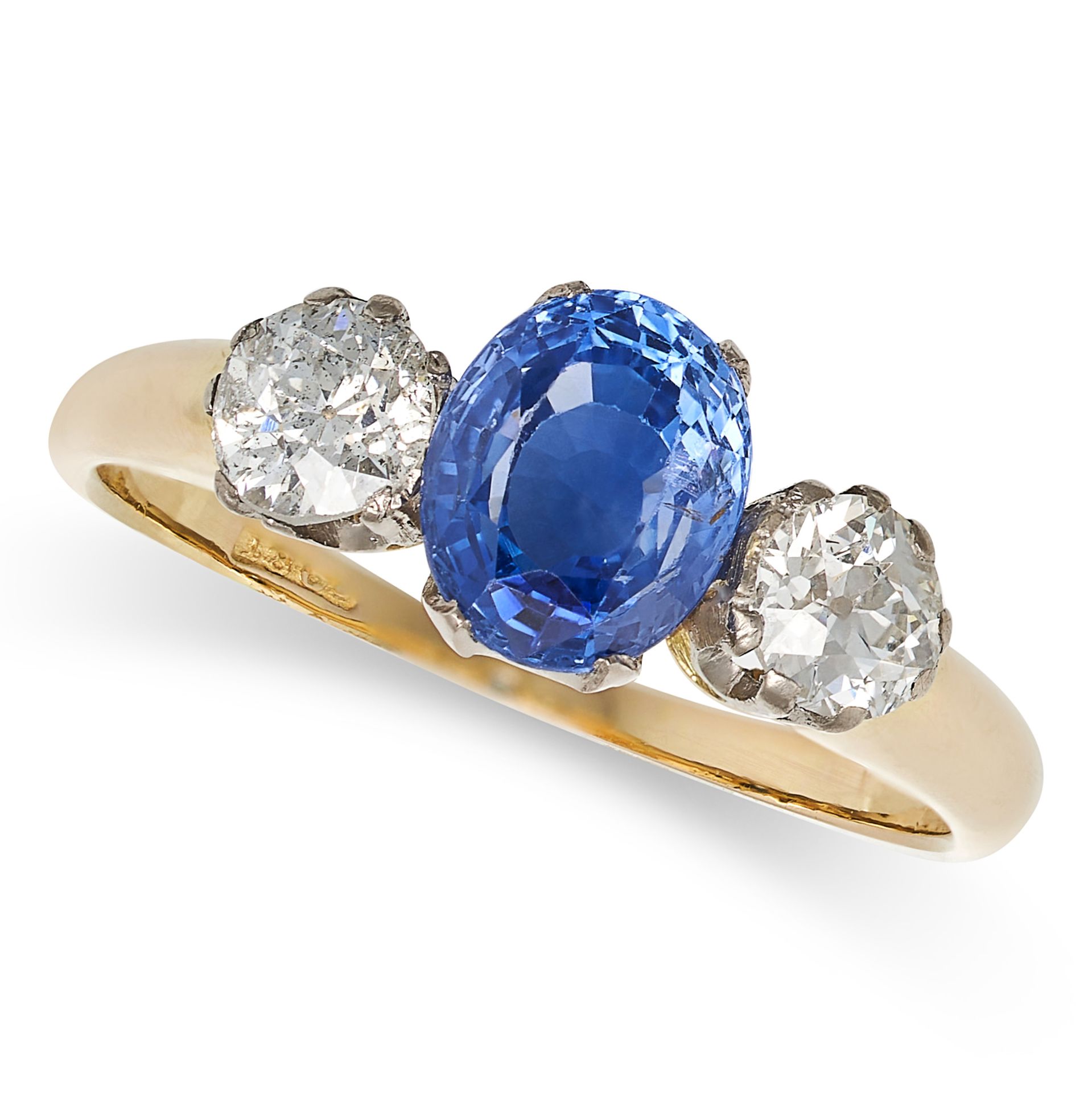 A BURMA NO HEAT SAPPHIRE AND DIAMOND THREE STONE RING in 18ct yellow gold, set with an oval cut s...