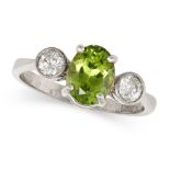 A PERIDOT AND DIAMOND THREE STONE RING in 18ct white gold, set with an oval cut peridot of approx...