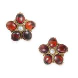 A PAIR OF GARNET AND PEARL FLOWER STUD EARRINGS in yellow gold, each set with a pearl accented by...