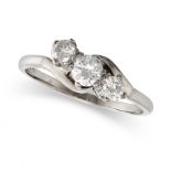 A DIAMOND THREE STONE RING in white gold, set with three round brilliant cut diamonds in a crosso...